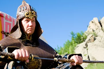 Tuinposter European wearing Mongolian armour © Alexander