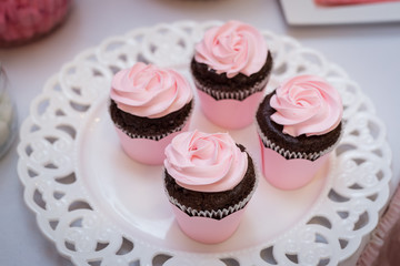 Tasty pink decoration cupcakes on stand close-up