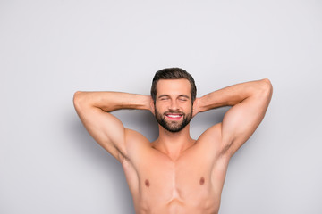 Attractive, stunning, manly, smiling macho isolated on gray background, having two arms behind the...