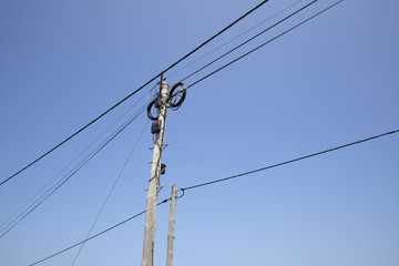 Electricity poles and lines against a blue sky