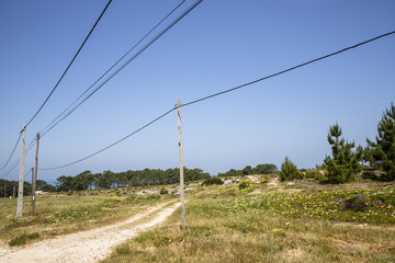 NAZARE, PORTUGAL - MAY 18, 2018.  Electricity poles and lines in the Portuguese landscape