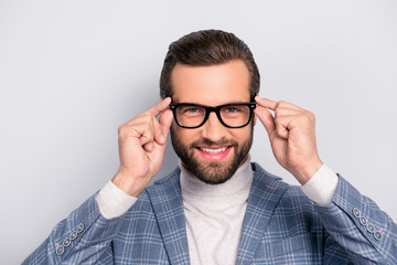 Portrait of gentlemen, manly, stunning,  modern man with hairstyle holding two eyelets of glasses...