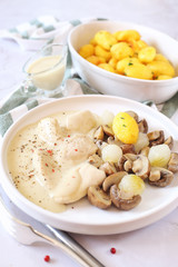 Chicken fricassee with sauce, fried potatoes and mushrooms