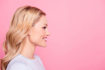Profile side view portrait with copy space empty place for product of nice cheerful girl with modern hairdo isolated on pink background