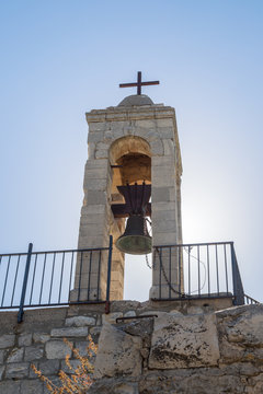The belfry with the bell of the functioning church of the Christian Maronites in the abandoned village Kafr Birim in the north of Israel
