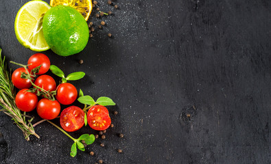 Cherry tomatoes on black background. Copy space