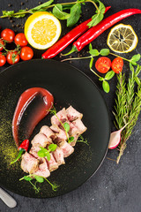 Fresh ham with sauce on black background