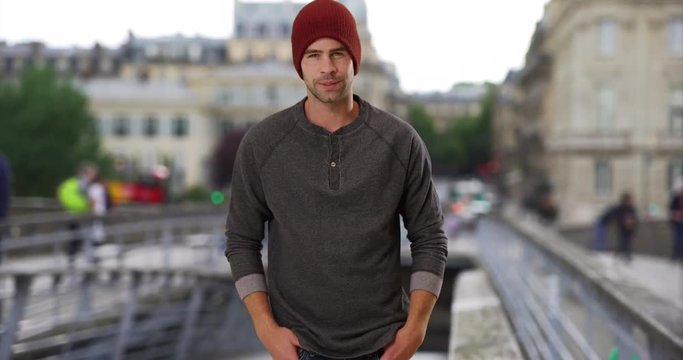 Casual portrait of sexy Caucasian male standing on Paris street, Cool and handsome guy smiling at camera outdoors, 4k