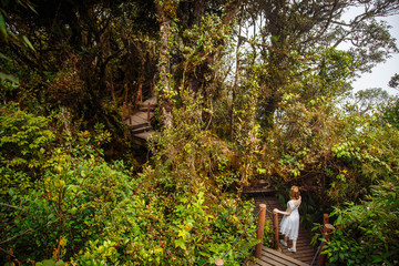 Girl walking in forest jungle