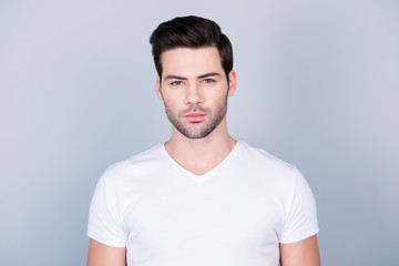 Portrait of perfect ideal man in white t-shirt with modern hairstyle soft smooth skin, isolated on grey background