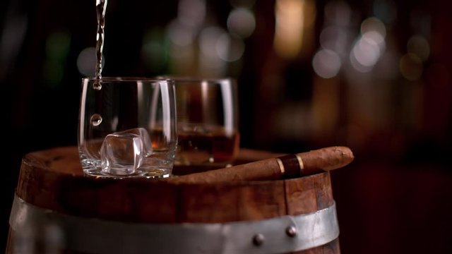Super slow motion of pouring whiskey into glass. Filmed on cinema slow motion camera, 1000fps, ProRes 422 HQ codec.
