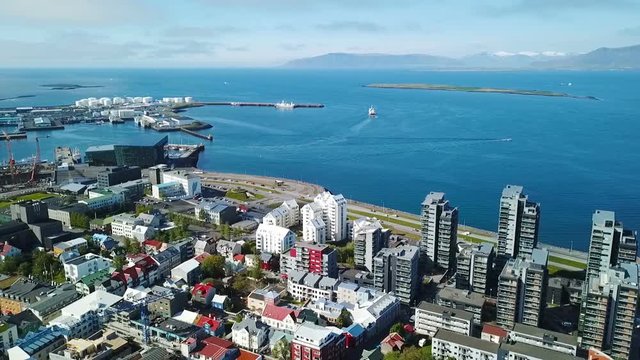 Reykjavik down town streets. oceanfront embankment and port. Aerial drone video footage flight. View from the top. Summer sunny daylight