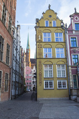 The facade of the beautiful historic building on the street of the Old Town of Gdansk. Poland. 