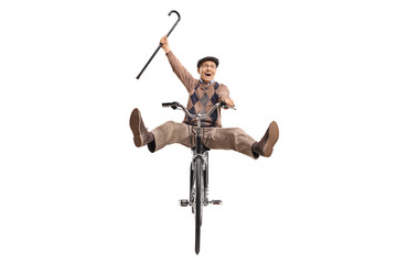 Fototapeta premium Overjoyed senior with a cane riding a bicycle