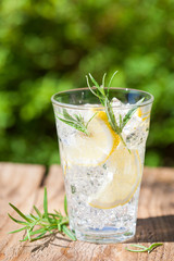 refreshing lemonade drink with rosemary in glasses
