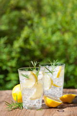 refreshing lemonade drink with rosemary in glasses