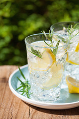 refreshing lemonade drink with rosemary in glasses