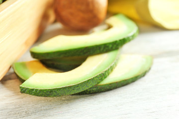 Fresh sliced avocado on table, closeup