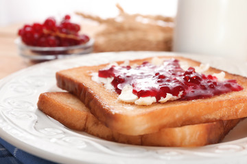 Tasty toasts with sweet jam on plate, closeup