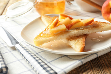 Tasty sweet toasts with pieces of peach on plate