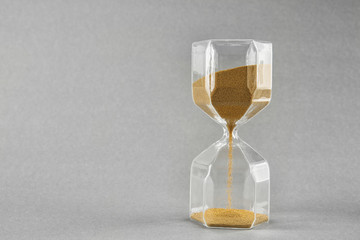Hourglass on grey background. Time management concept