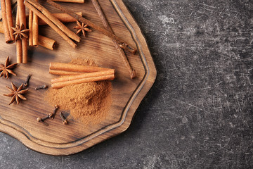 Composition cinnamon and spices on wooden board