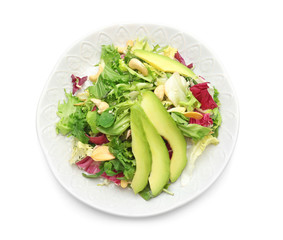 Plate of tasty salad with ripe avocado on white background
