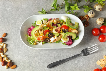 Plate of tasty salad with ripe avocado on table