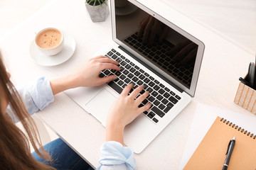 Fototapeta na wymiar Female freelancer working on laptop in home office