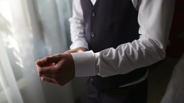 Wedding. The Groomy Fastens His Shirt