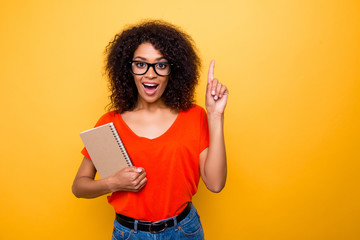 Portrait with copyspace of impressed astonished girl in eyewear pointing forefinger up find great...