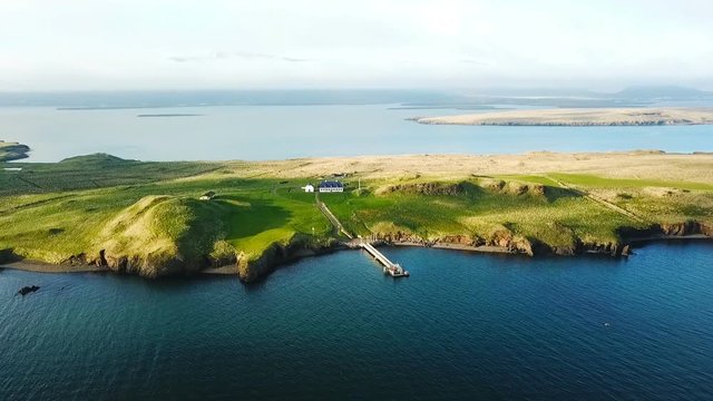 House on the iseland Reykjavik Iceland. Aerial video footage from the top. Ocean water. mountains in the background