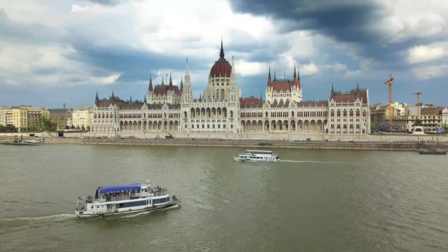 Budapest, Hungary - Sightseeing boat on River Danube next to Hungarian Parliament at daytime