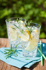 refreshing lemonade drink with rosemary in glasses