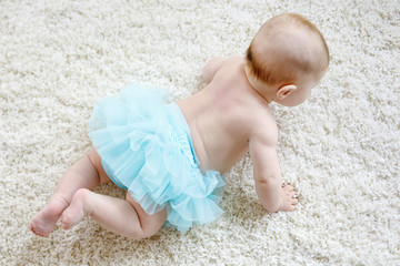 Adorable baby girl on white background wearing turquoise tutu skirt. © Irina Schmidt