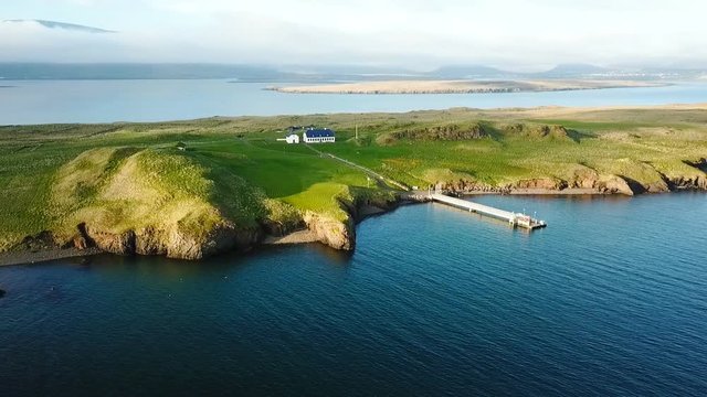 House on the iseland Reykjavik Iceland. Aerial video footage from the top. Ocean water. mountains in the background