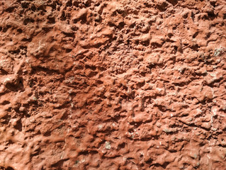 Ribby red texture background. Old vintage concrete wall. Vertical photo.