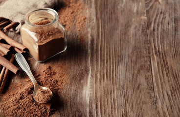 Composition with cinnamon on wooden background