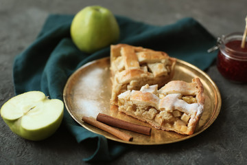 Plate with pieces of tasty homemade apple pie on table