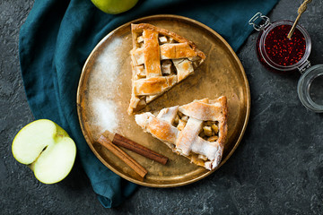 Plate with pieces of tasty homemade apple pie on table