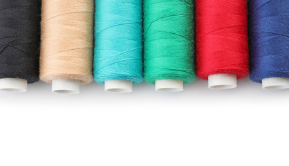Set of sewing threads on white background