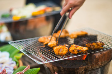 Chicken legs on the grill with flames