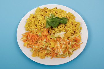 Baked Bulgar with cauliflower and vegetable salad on a blue