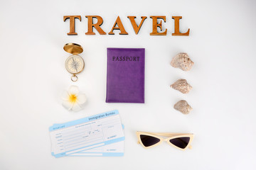 Composition with passport, compass and word "Travel" on white background
