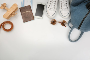 Composition with passport, smartphone and accessories on white background. Travel planning concept