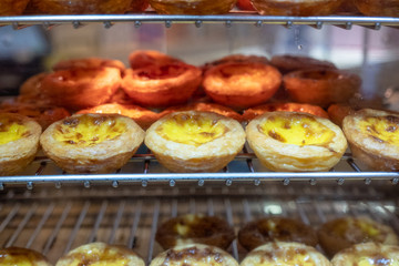 Egg tart with custard cream baking on grille. Sweet dessert traditional in asian