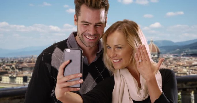 Joyful newly engaged couple take a selfie in Florence, Man and woman take a picture together to share the news with friends, 4k
