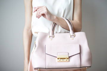 young woman with light pink handbag, romantic casual style