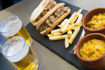 Beer and spanish tapas, paella and french fries