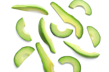 Slices of ripe avocado on white background